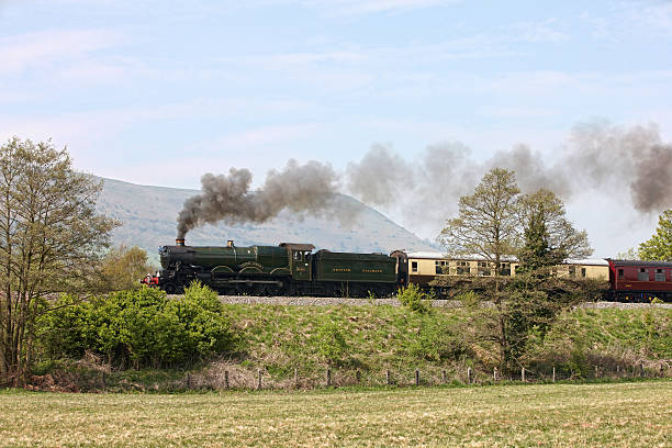 View of a Victorian locomotive, Llangollen, UK.  People can be seen on the bridge