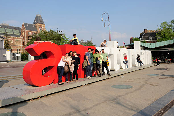 AMSTERDAM - OCTOBER 20, 2013: Young uploaded to letters of 'I Amsterdam' logo at Museum Square on October 20, 2013. It is a city marketing initiative developed in 2005 as a means for Amsterdam to profile itself internationally.