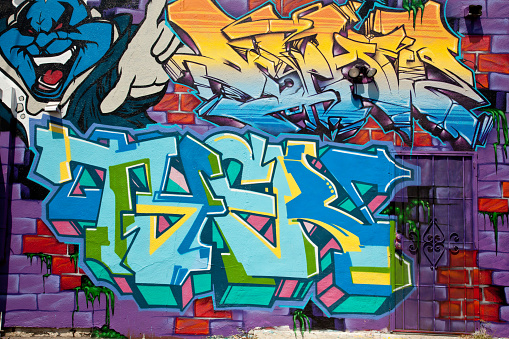 Melbourne, Australia - December 10, 2021: Melbourne, the capital of Victoria and the second largest city in Australia, has gained international acclaim for its diverse range of street art and associated subcultures. Overlooking a graffiti painted alley in Melbourne, Australia.