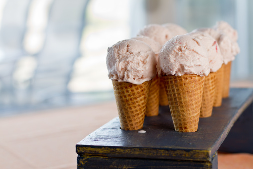 Strawberry Ice Cream Cones in a wooden rack on a table