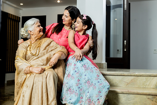 Grand Mother,Daughter , grandchildren together in ethnic wear celebrating festival look,Multi generation Females together bonding