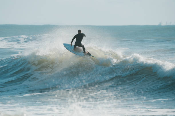 istock A surfer in wetsuit riding the wave on short surfboard 1577780969