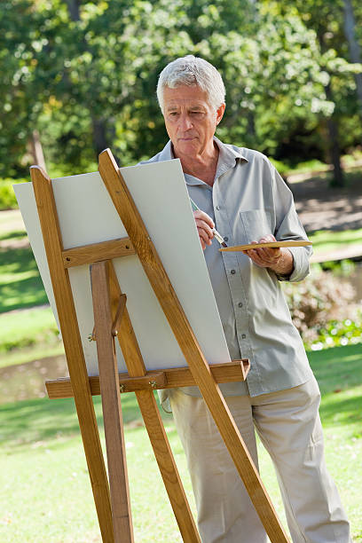 istock Old man painting on a canvas in the park 157778722