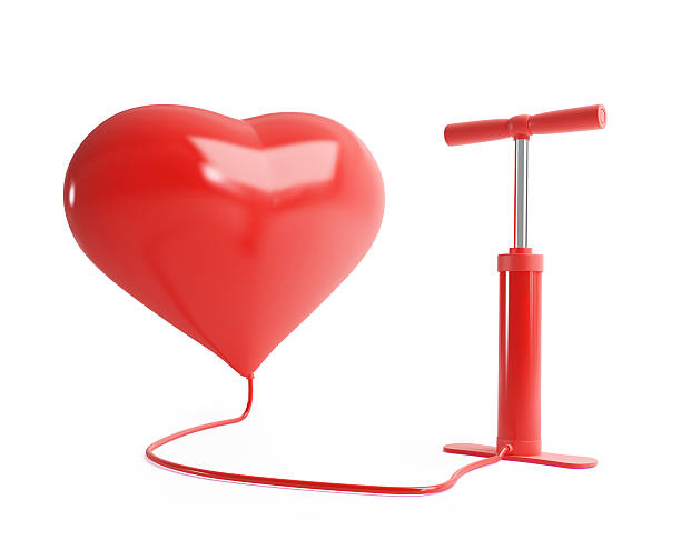 Red heart balloon getting inflated by a red pump heart pump on a white background air pump stock pictures, royalty-free photos & images