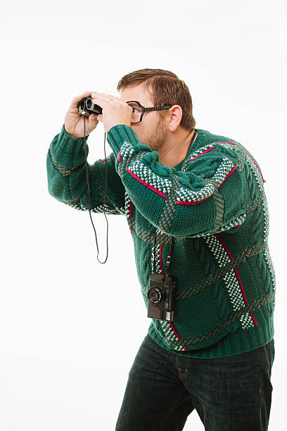 Man looking through binoculars stock photo