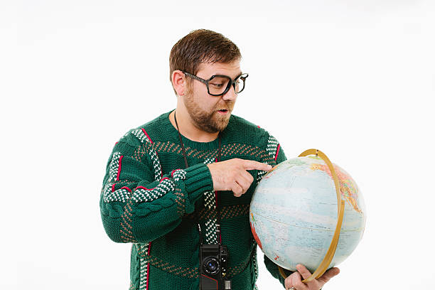 Nerdy man holding globe. stock photo