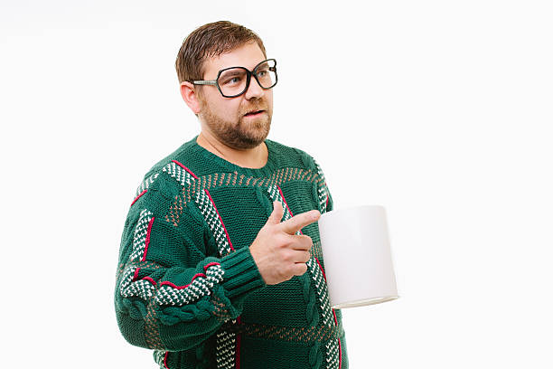 Nerdy man pointing with coffe cup stock photo