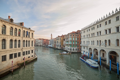 Beautiful view of traditional Gondola on famous Canal Grande with Rialto Bridge in Venice, Italy