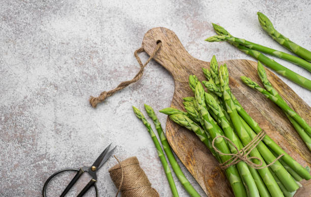 istock Fresh green asparagus on  concrete background. 1577815746