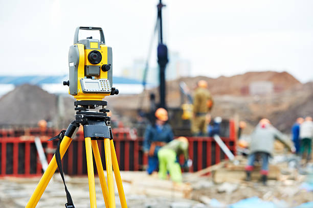 surveyor equipment theodolite at construction site stock photo