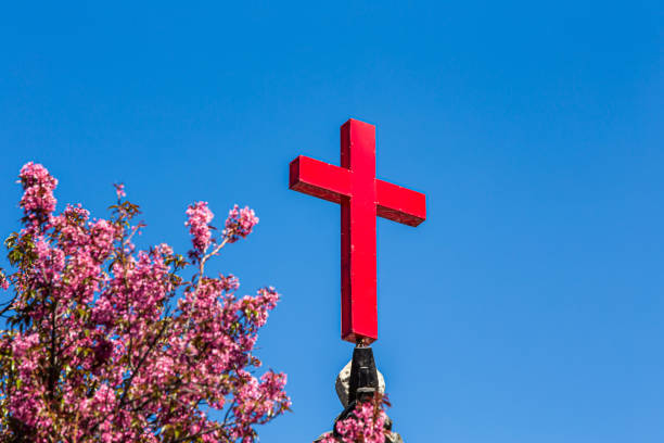 istock Red Christian cross on the blue sky background. 1577818917