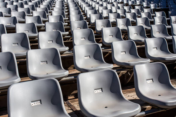 istock Rows of white plastic chairs on a wooden deck in the park 1577819979