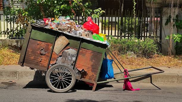 istock Old rustic garbage cart in urban area 1577832482