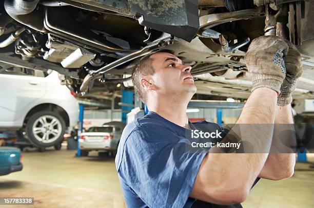 Auto Mechanic At Car Suspension Repair Work Stock Photo - Download Image Now - Mechanic, Adult, Auto Mechanic