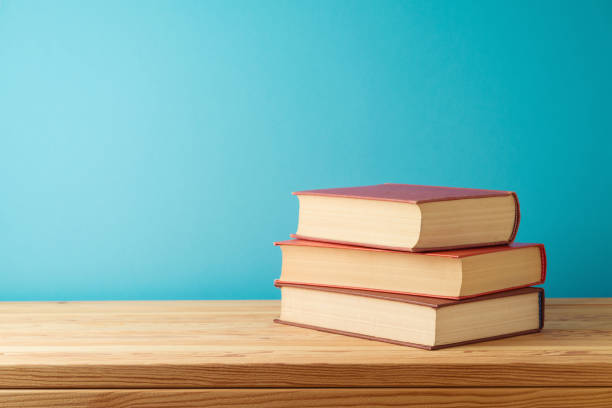 istock Books on wooden table over blue background. Back to school concept 1577875786