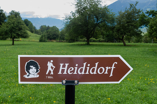 Maienfeld, Switzerland - July 25, 2023: Direction sign to the village of the film and cartoon character Heidi near Maienfeld in swiss canton of Graubunden -Grisons.
