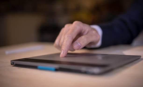 istock business and technology concept, businessman hand using touch pad working in office 1577900741