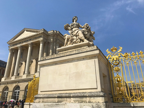 Paris, France: 07/24/2019 - Palace Of Versailles, Apollo fountain, Versailles gardens, during summer time against blue sky