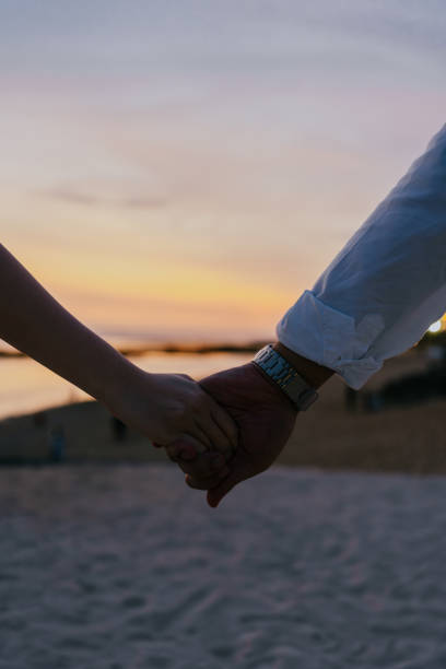 istock Woman and man hands holding hands. 1577924971