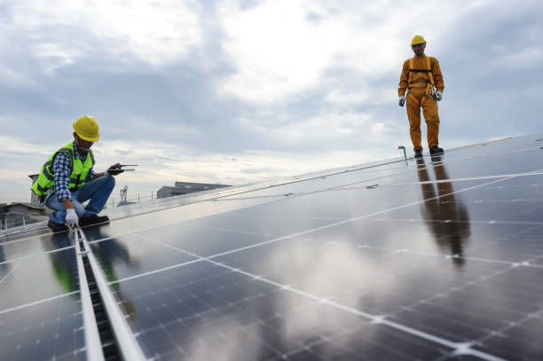 istock Technician Inspector Quality in Solar Roof Panel Installation with Installer, Quality Control in Work of Sustainable Photovoltaic Installation on Factory Roof Buildings. 1577998408