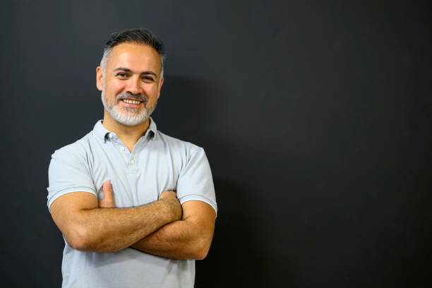 istock Smiling teacher standing at the blackboard 1578011181