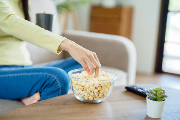 istock Asian woman Watching smart TV and using remote controller Hand holding television audio remote control at home with the remote control television 1578019109