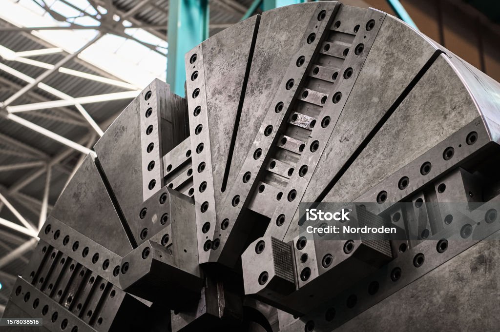 Base plate of huge lathe machine tool in plant workshop Operating base plate of huge heavy lathe machine tool in spacious metal-processing plant workshop extreme close low angle shot Closed Stock Photo
