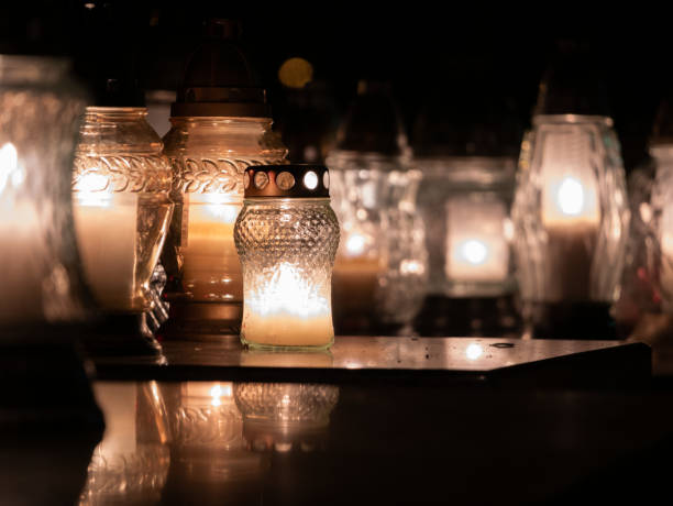 Cemetery grave candle lanterns or znicz, illuminated at night. Cemetery grave candle glass lanterns illuminated at night. All Saints' Day, Feast of All Souls. Commemoration of All the Faithful Departed and the Day of the Dead. lanterns at night stock pictures, royalty-free photos & images