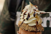 Trdelnik from Czech republic. Trdelnik or trdlo - traditional Czech dessert in the form of a spit cake. Delicious pastries filled with ice cream. National cuisine.