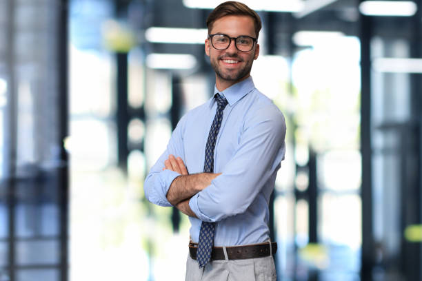 istock Young handsome businessman smiling in an office environment 1578103797