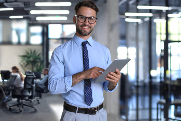 istock Young businessman using his tablet in the office. 1578104311