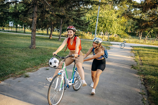 Young woman having city break with riding bike in the nature