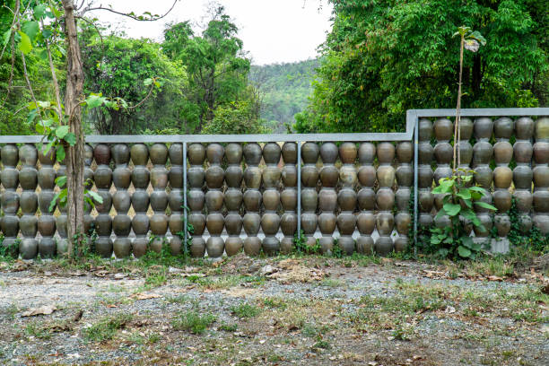 Fence made from earthen jar background. Pottery jar wall in the garden.