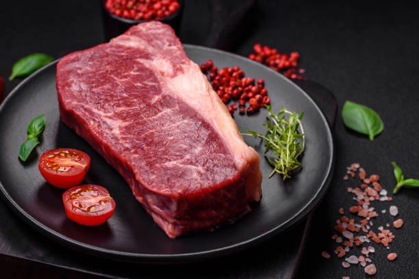 istock Fresh raw beef striploin steak with salt, spices and herbs 1578164243