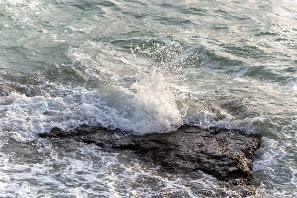 istock Tranquil waves striking against the rock. 1578169614