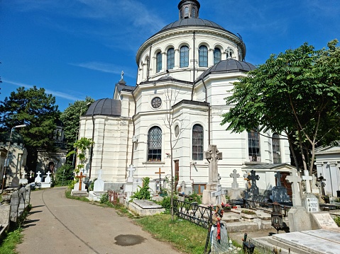 Șerban Vodă Cemetery (commonly known as Bellu Cemetery) is the largest and most famous cemetery in Bucharest, Romania. The image shows sveral graves at the Bellu Cemetery captured during summer season.