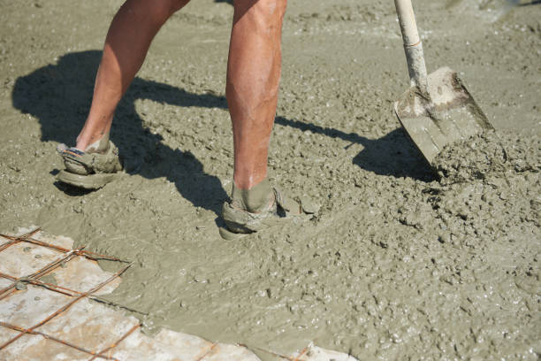 istock Soiled construction worker stands with his feet in concrete on a construction site 1578187586
