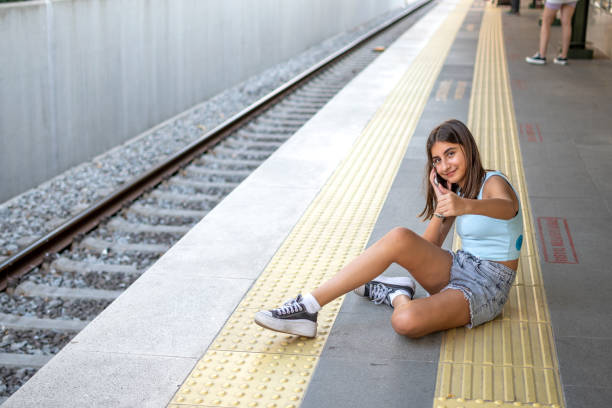 Modern station tram and subway travel, girl using phone