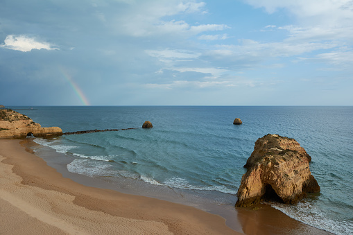 Beautiful rainbow over the Praia dos Tres Castelos in Portimao, Algarve, Portugal