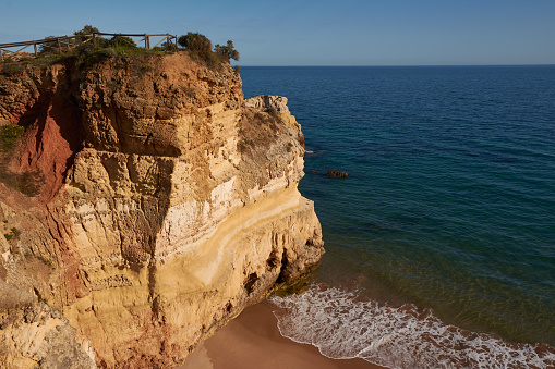 Beautiful view of the beach Praia dos Careanos and the viewpoint on the top of the rock. Algarve coast, Portugal