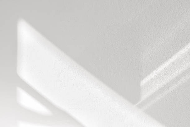 istock White wall background,Concrete texture with Shadow diagonal,Empty Cement  room with Sunlight reflect on white plaster paint,Light effect for Monochrome photo, mockup, Product Design presentation 1578255117