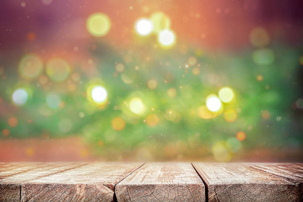 istock An empty wooden table with a fir branch on a blurry background and a backlight. Product Demonstration 1578257237