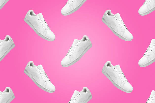 istock Pattern of white sneakers isolated on pink background. 1578266408