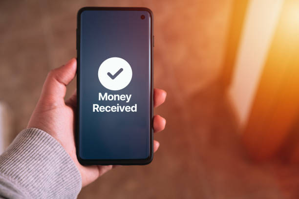 istock Woman transfering money online using apps on smartphone. Selective focus. 1578266410