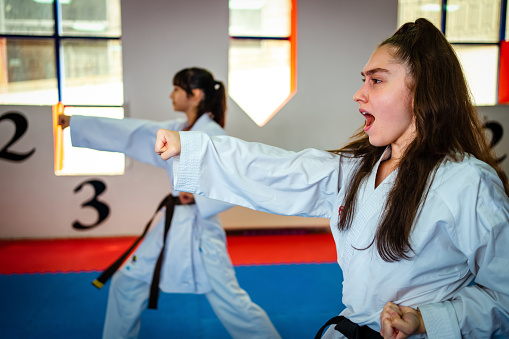 Teenage girl training during a karate class