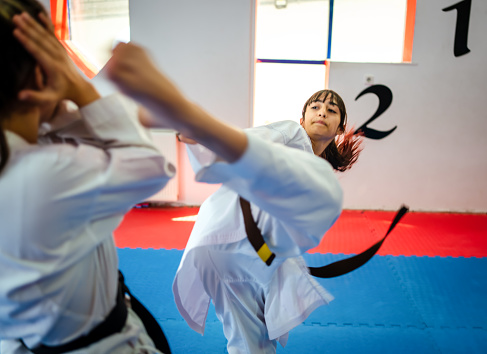 Teenage girl training during a karate class