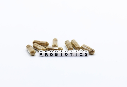 Probiotic capsules on white background.