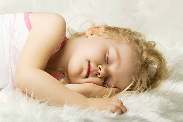 istock sleeping little girl in bed 157829028