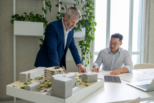 istock Architect men, teamwork and planning blueprint with discussion, construction goal or vision. 1578297491