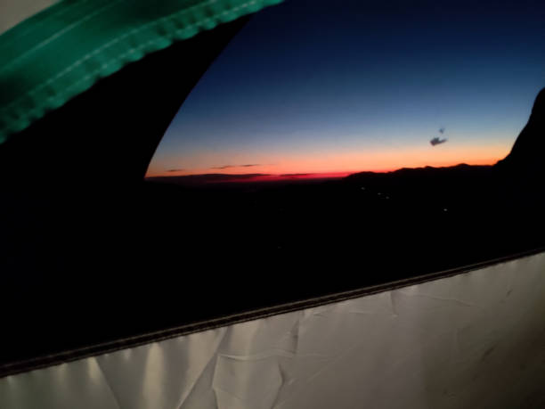 istock Mesmerizing orange horizon over mountain peaks, seen from inside a tent during camping in Uttarakhand, India. Breathtaking experience 1578298074